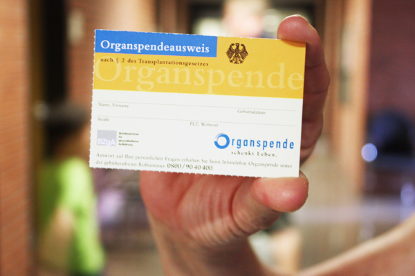 eine Hand, die einen Organspendeausweis hält.