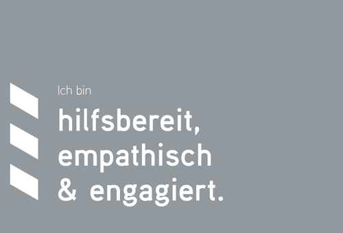 Graue Texttafel mit weißer Schrift: Ich bin hilfsbereit, empathisch und engagiert