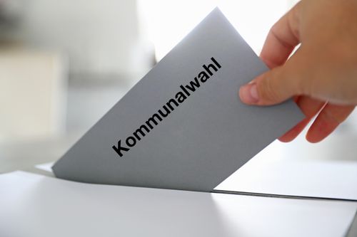 Ein Wahlbrief wird in die Wahlurne geworfen